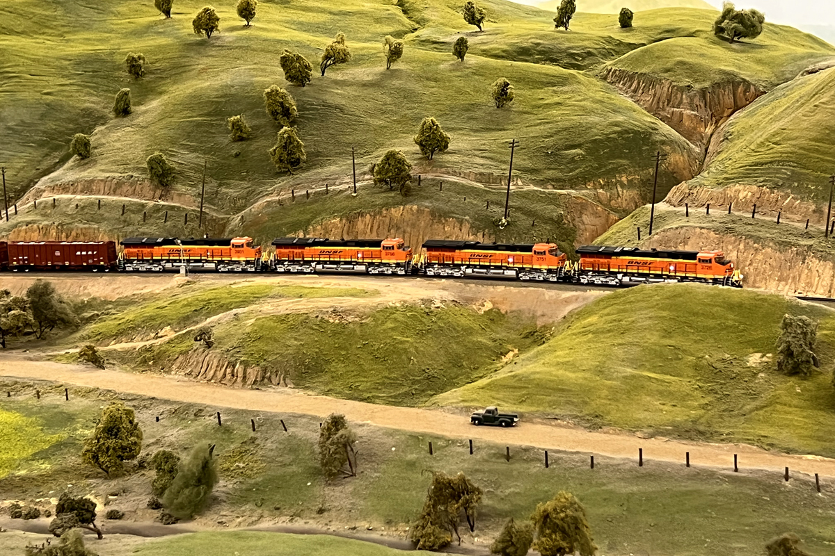 Pictured above is some scenery at the HO scale La Mesa Model Railroad Club. You can notice the rock formations, a road, trees, ground cover and more. Pictured above is some scenery at the HO scale La Mesa Model Railroad Club. You can notice the rock formations, a road, trees, ground cover and more.