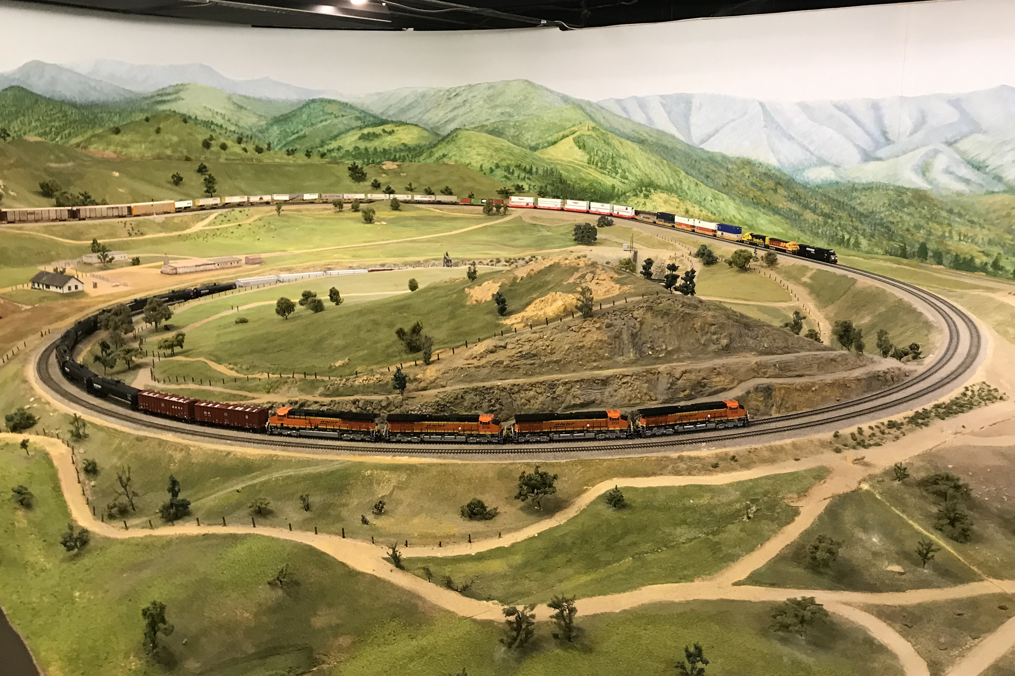La Mesa Model Railroad Club with two trains passing each other on the Tehachapi Loop.